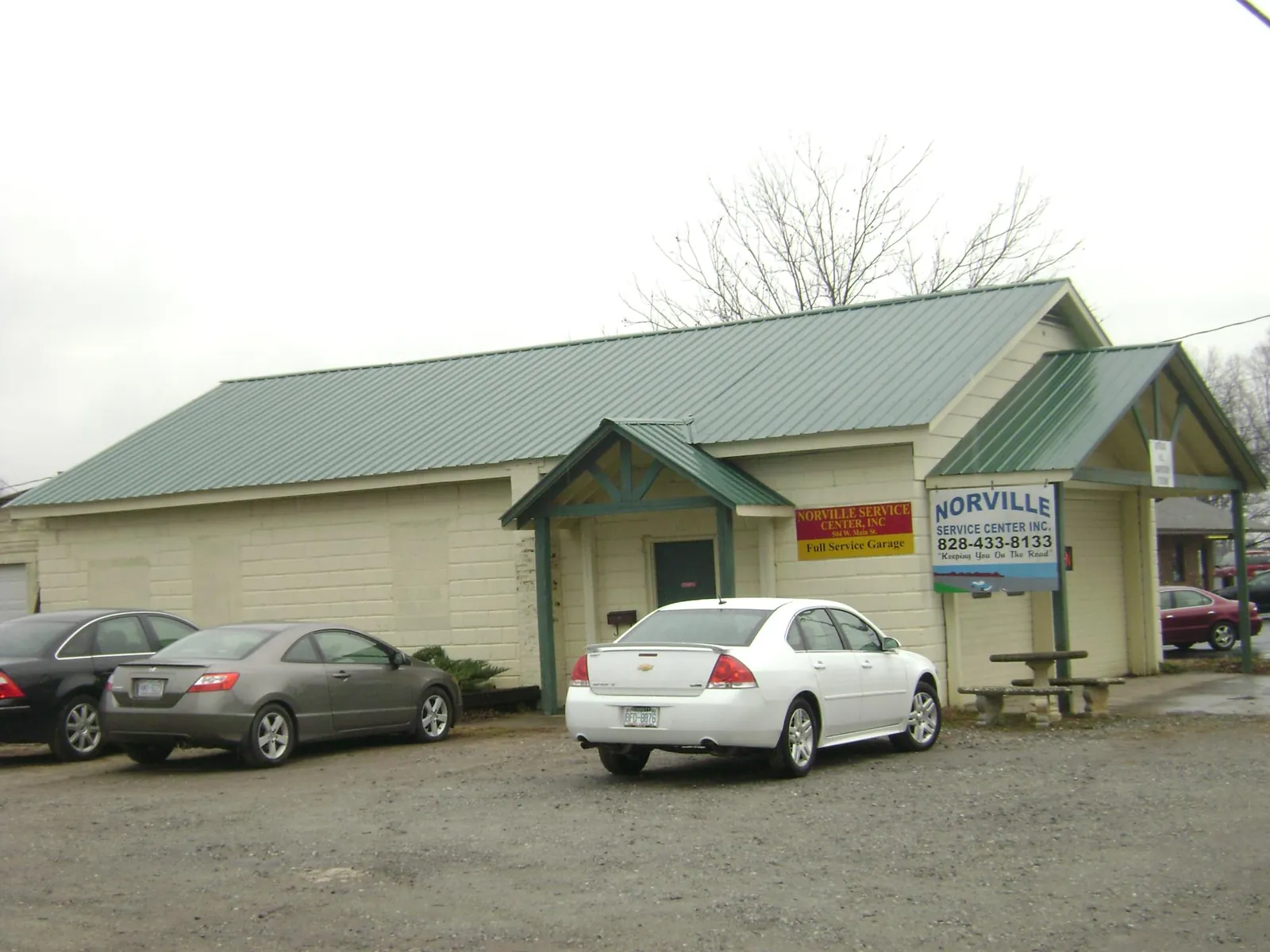 Green metal roof on a service garage with a covered entry in Blue Creek